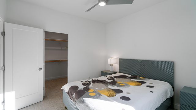 a bed sitting in a bedroom next to a window