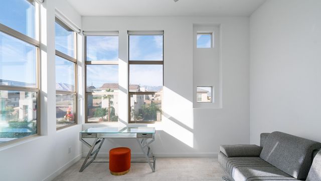 a bedroom with a bed and a large window