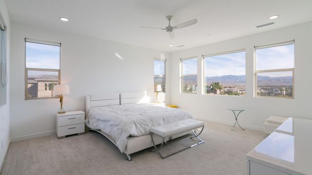 a bedroom with a bed couch and a window
