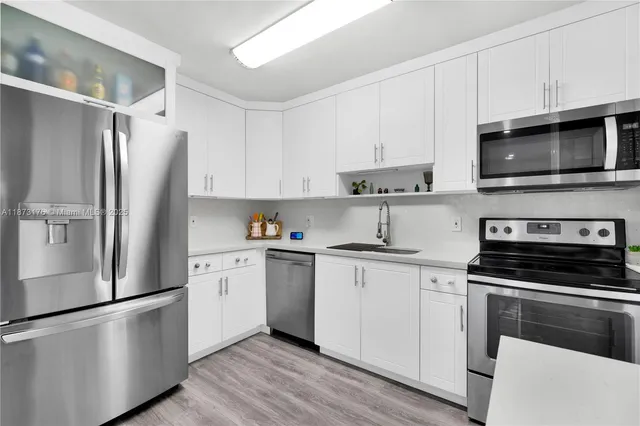 a kitchen with a stove a sink and a microwave