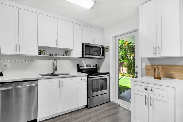 a utility room with cabinets washer and dryer