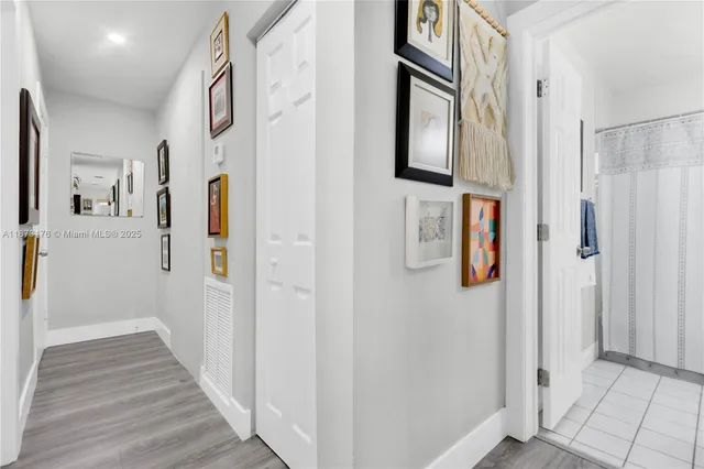 a bathroom with a sink a toilet and shower curtain