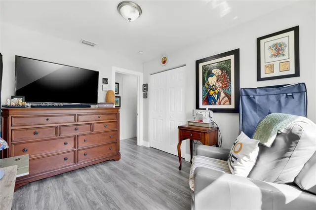 a bedroom with a bed and a dresser