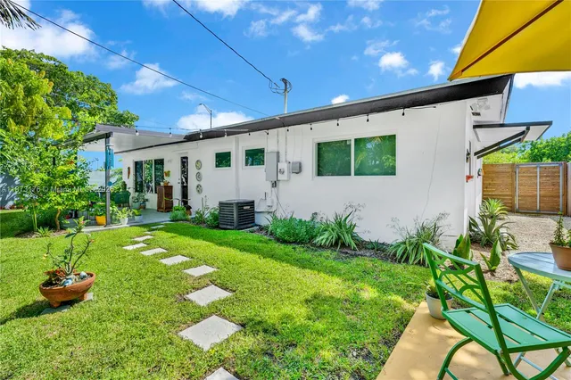 an aerial view of residential houses with outdoor space and street view