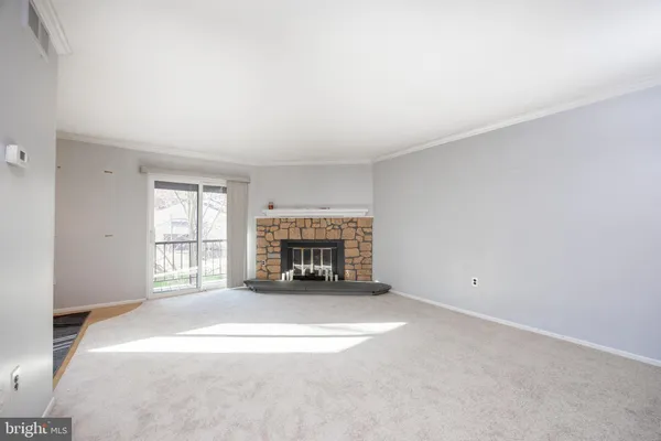 a view of an empty room and glass door