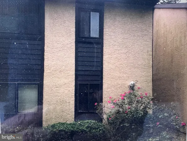 a kitchen with white cabinets a sink dishwasher and a stove with wooden floor