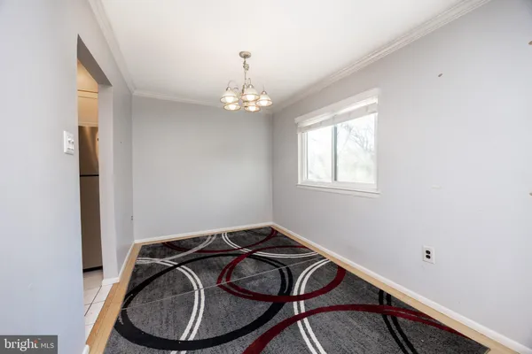 a view of an empty room with fire place and a window
