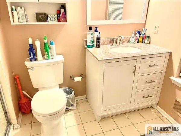 a bathroom with a sink mirror vanity and toilet