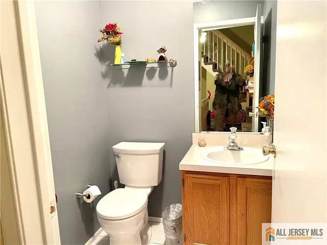 a bathroom with a toilet sink and mirror