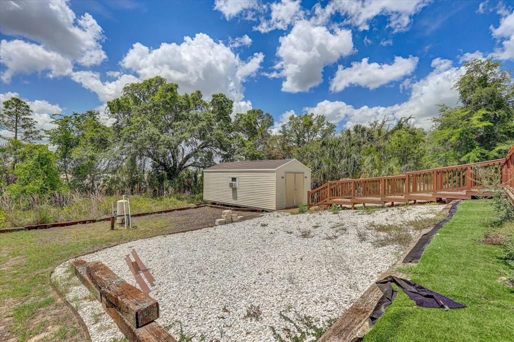 7314 Madrid Road Weeki Wachee, FL 34613 - Photo 32 of 54 a backyard of a house with lots of green space