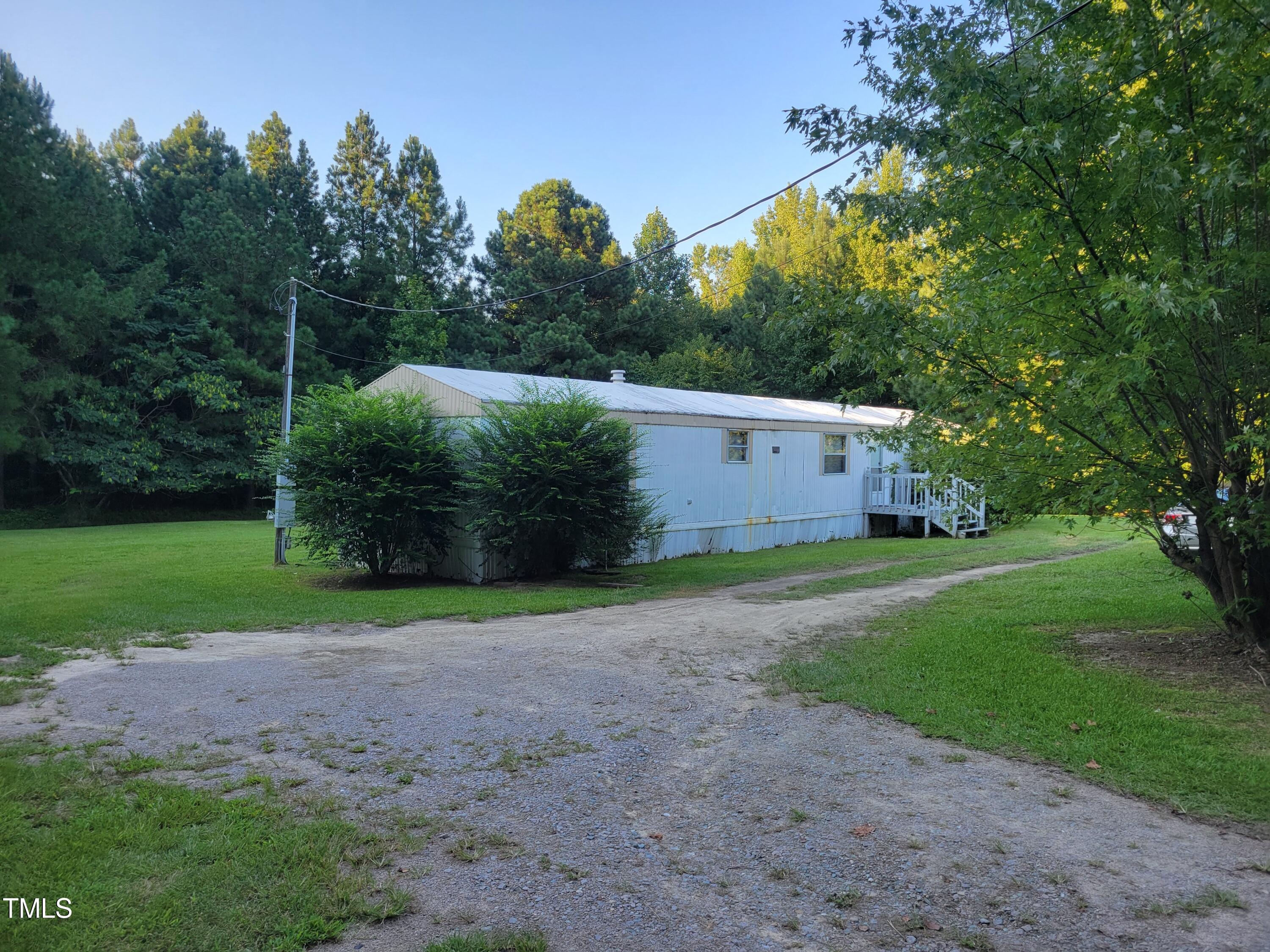 4044 Chris Cole Road Sanford, NC 27332 - Photo 10 of 16 a view of a backyard with large trees and plants