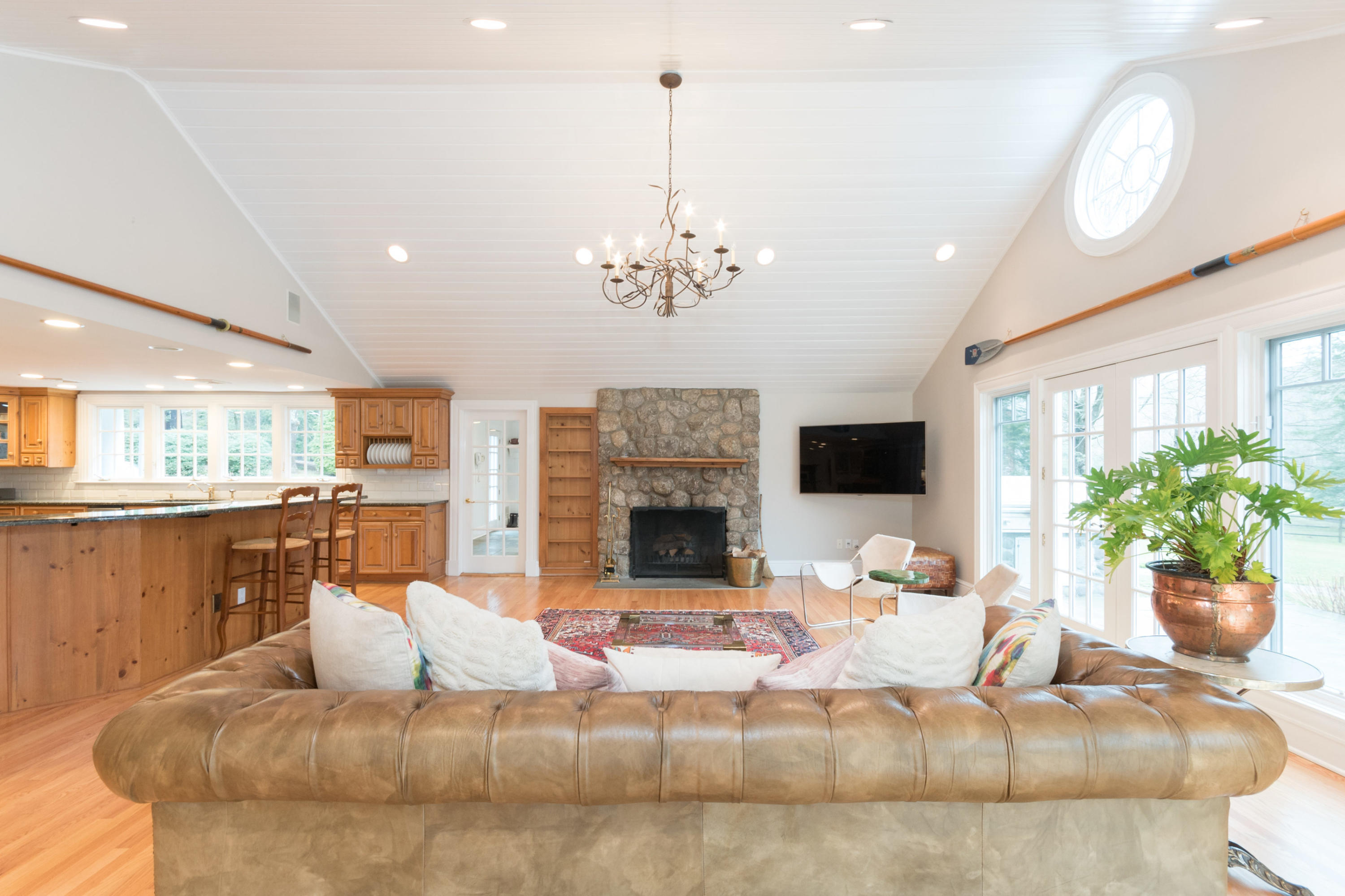 783 Valley Road New Canaan, CT 06840 - Photo 11 of 28 a living room with furniture a fireplace and a chandelier