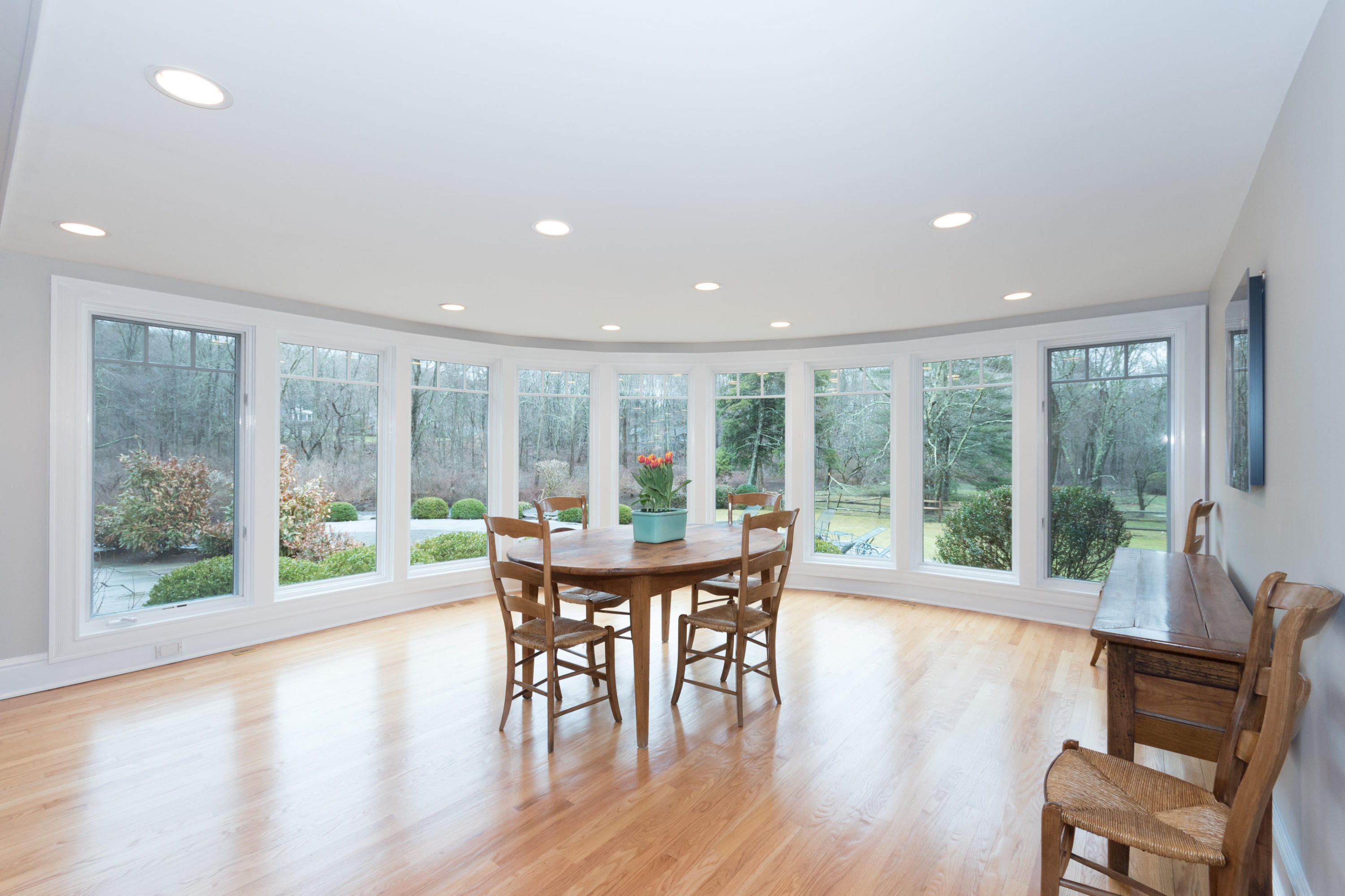 783 Valley Road New Canaan, CT 06840 - Photo 12 of 28 a dining room with furniture wooden floor and a rug