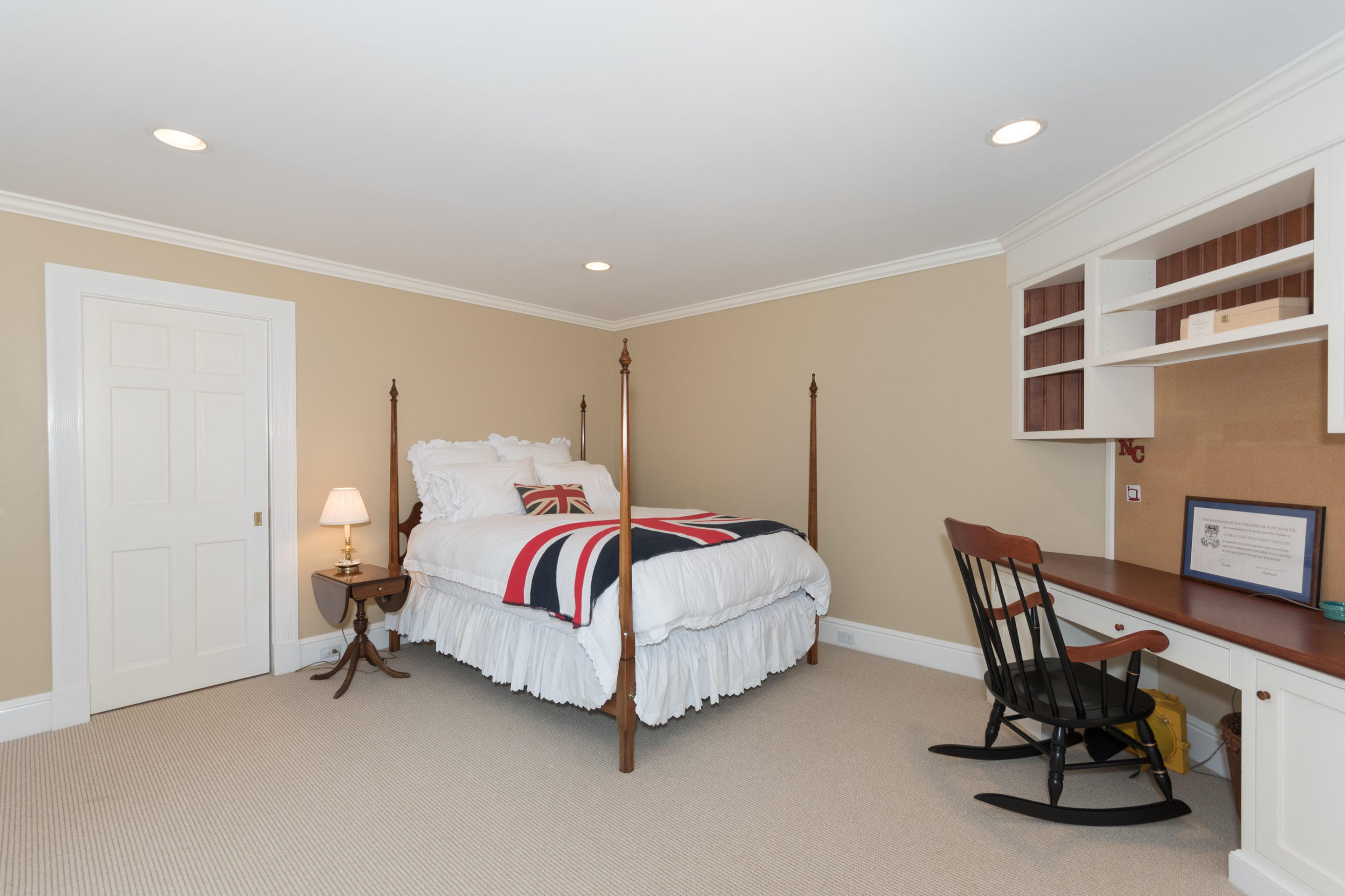783 Valley Road New Canaan, CT 06840 - Photo 19 of 28 a spacious bedroom with a bed and a table in it
