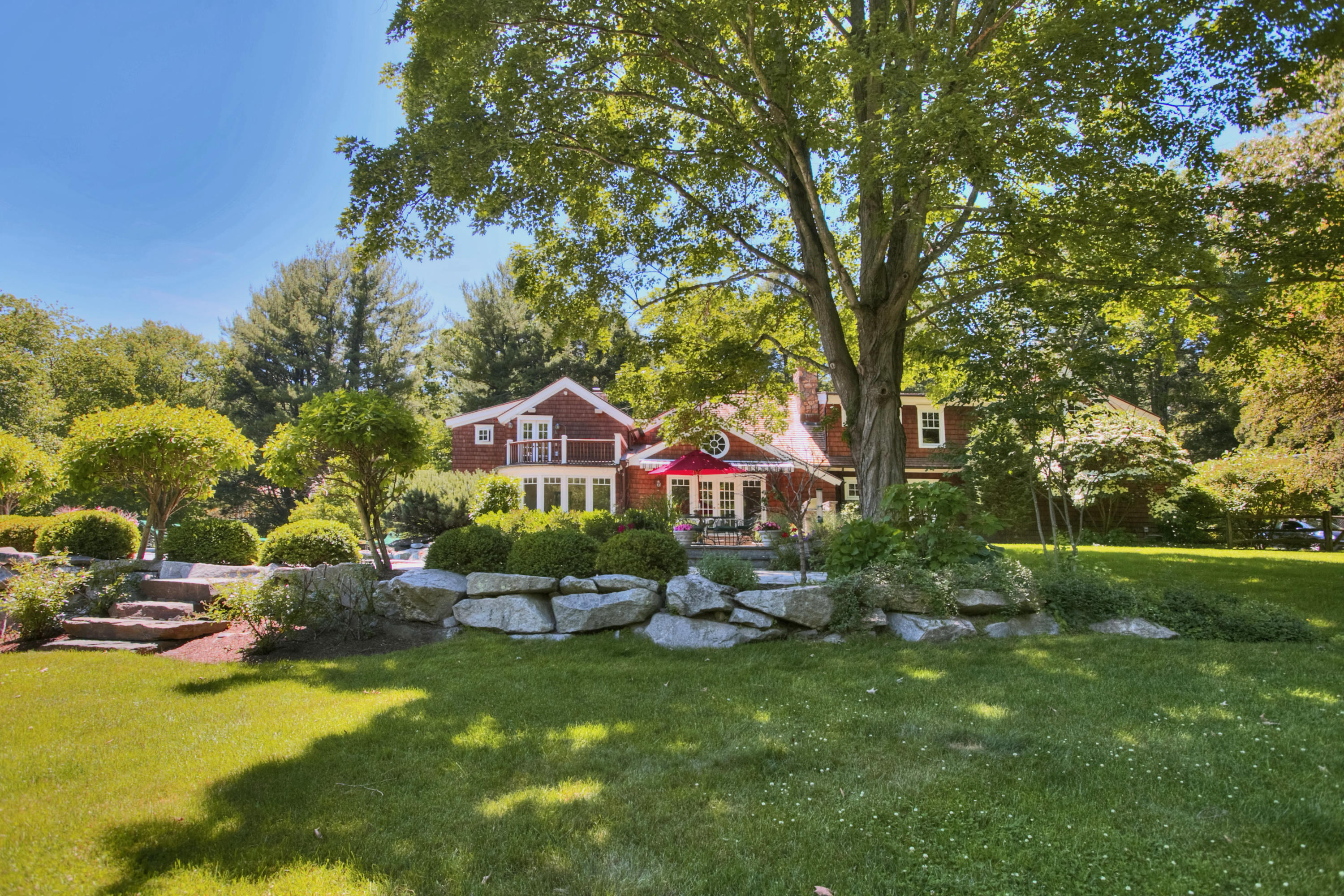 783 Valley Road New Canaan, CT 06840 - Photo 24 of 28 a front view of a house with yard and green space