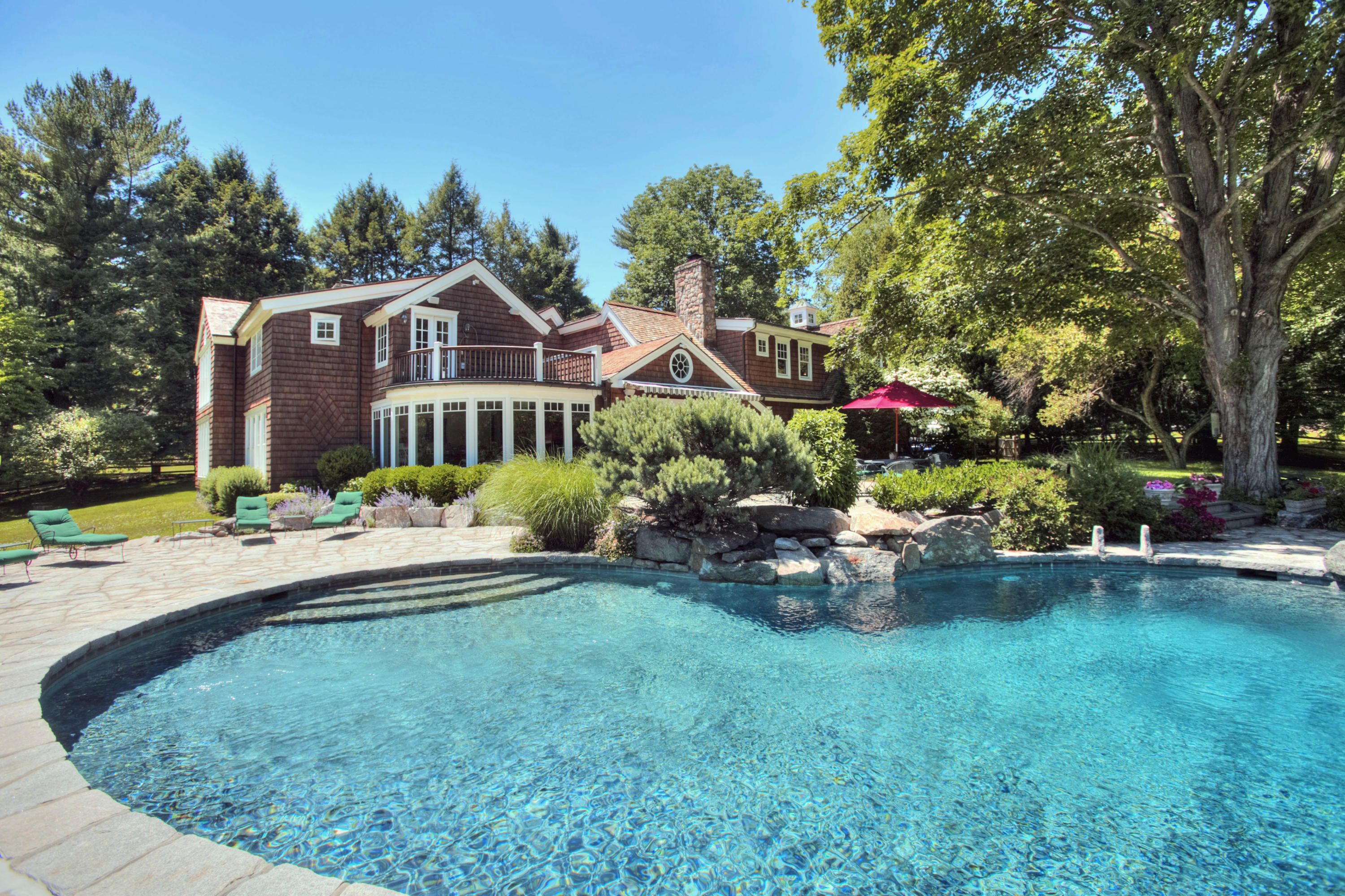 783 Valley Road New Canaan, CT 06840 - Photo 5 of 28 a view of a house with a backyard and sitting area