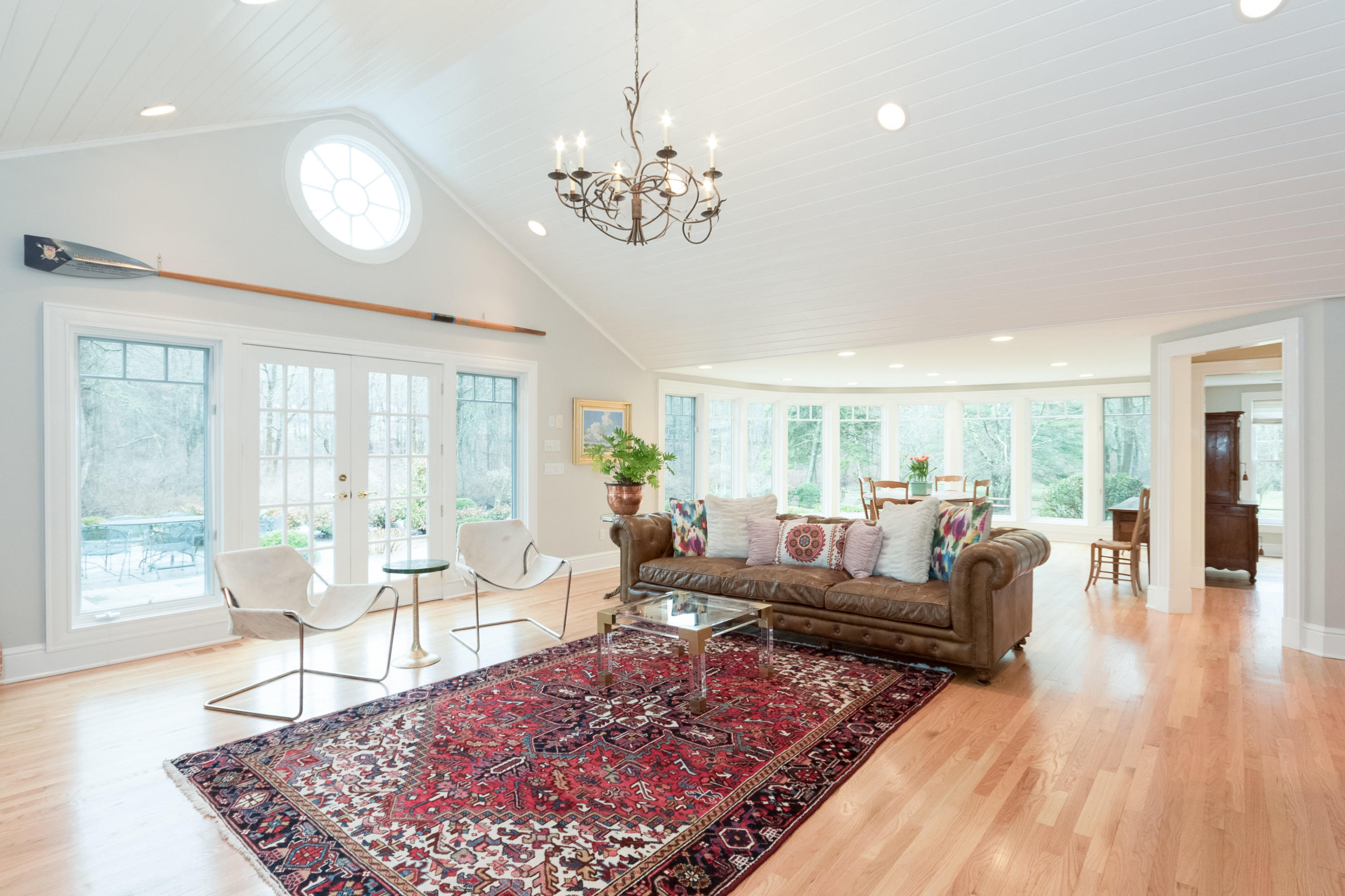 783 Valley Road New Canaan, CT 06840 - Photo 9 of 28 a living room with furniture a large window and a dining table