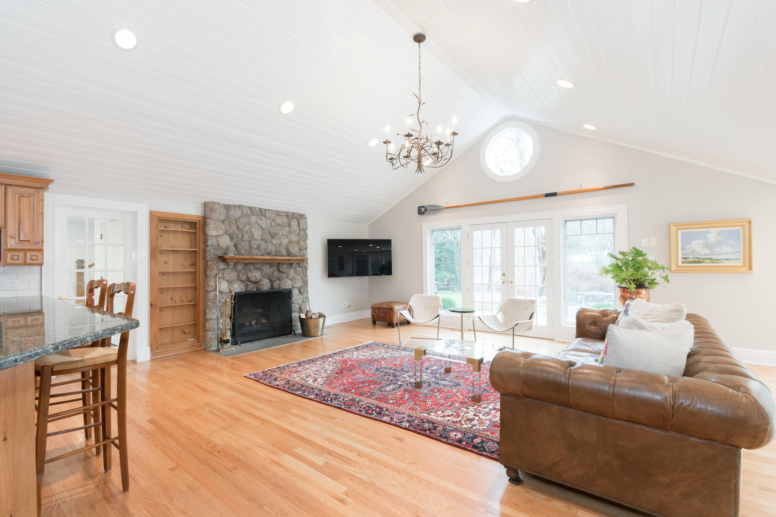 783 Valley Road New Canaan, CT 06840 - Photo 10 of 28 a living room with fireplace furniture and a chandelier