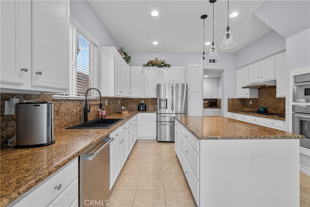 29350 Las Brisas Road Valencia, CA 91354 - Photo 15 of 75 a large kitchen with granite countertop a sink a counter top space stainless steel appliances and cabinets