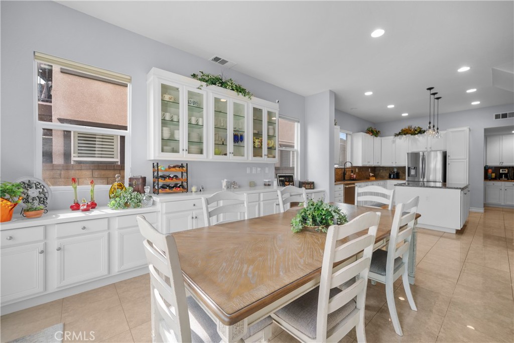 29350 Las Brisas Road Valencia, CA 91354 - Photo 18 of 75 a kitchen with stainless steel appliances kitchen island granite countertop a stove a sink a refrigerator with white cabinets and couches