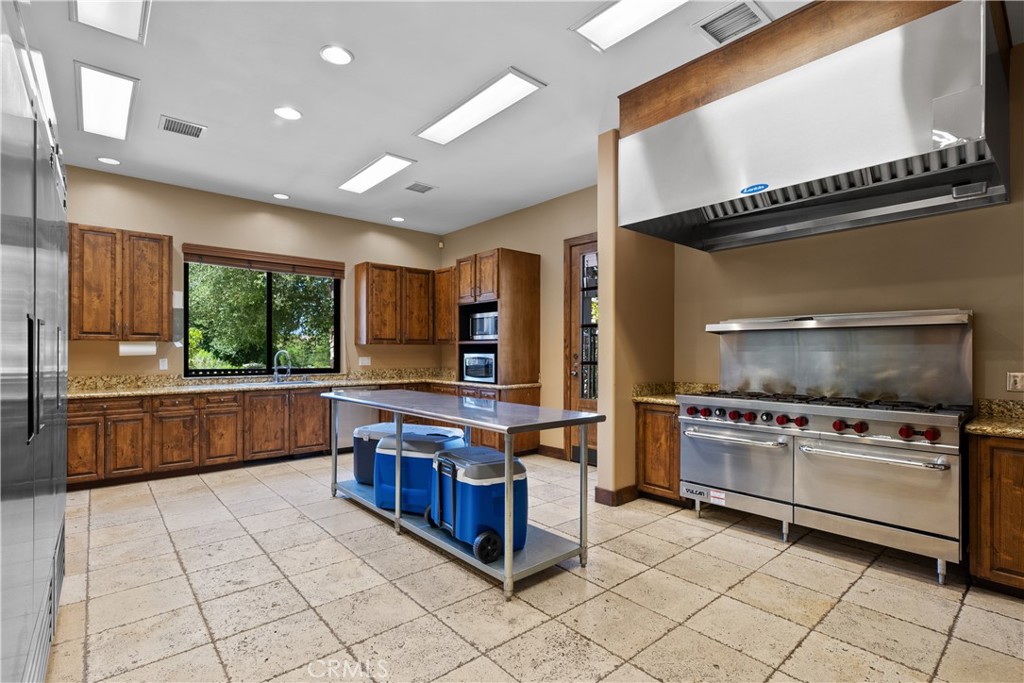 29350 Las Brisas Road Valencia, CA 91354 - Photo 61 of 75 a kitchen with stainless steel appliances a stove a sink and a refrigerator