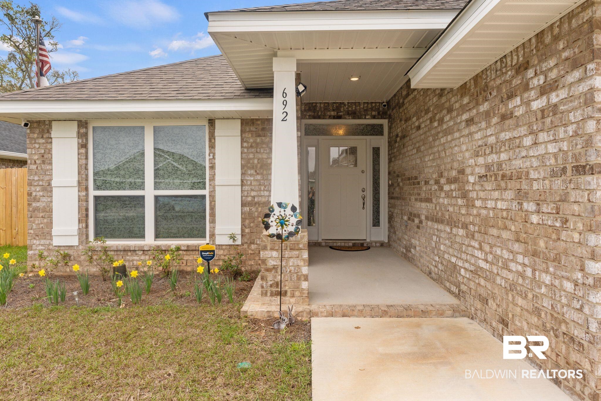 692 Mayflower Drive Foley, AL 36535 - Photo 4 of 40 Doorway to property featuring brick siding, roof with shingles, and a porch