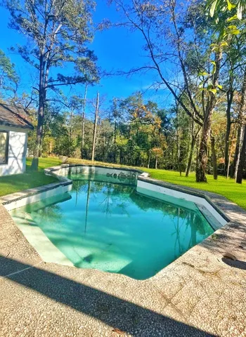 a view of a backyard with swimming pool