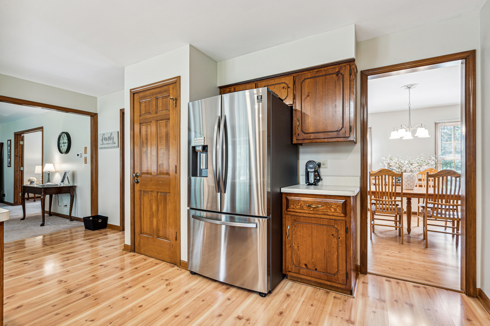 766 Raintree Drive Naperville, IL 60540 - Photo 8 of 30 a kitchen with granite countertop a refrigerator a stove and a wooden floors