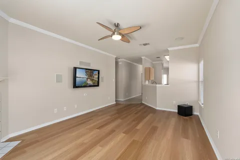 a view of empty room with wooden floor