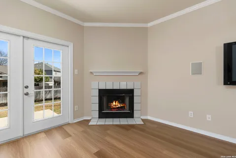 a living room with a fireplace with wooden floor