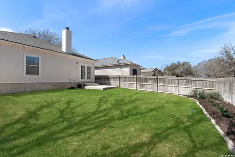 a view of a house with a backyard and a garden