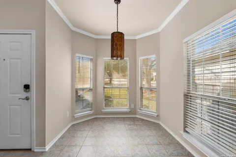 a hallway with windows and chandelier