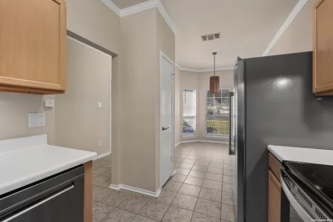 a kitchen with a refrigerator and a stove top oven