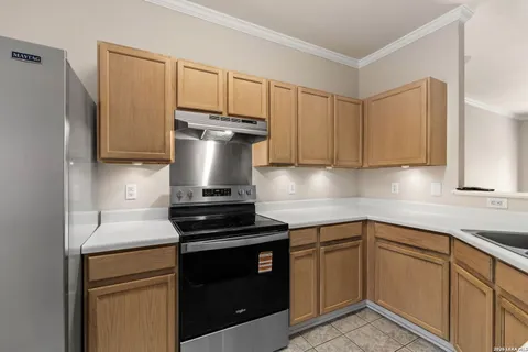a kitchen with a sink and a stove top oven