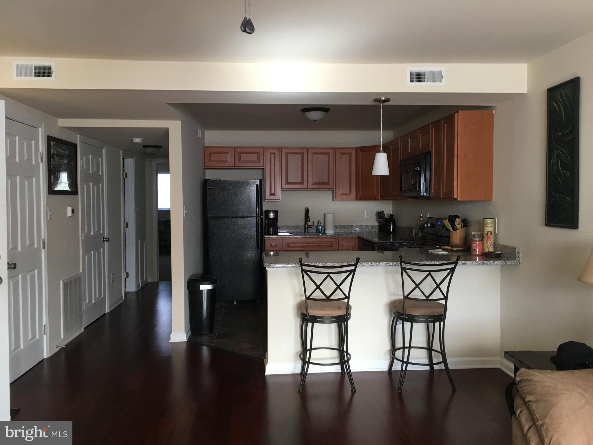 1 Pennsylvania Road, Unit 15 Glassboro, NJ 08028 - Photo 1 of 37 a kitchen with stainless steel appliances granite countertop a stove top oven a sink and cabinets