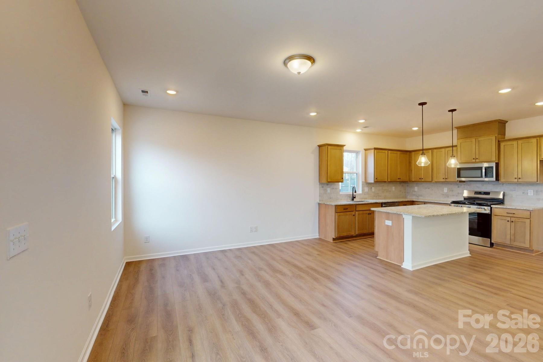 929 Barker Street Monroe, NC 28112 - Photo 15 of 26 a large kitchen with a lot of counter space and stainless steel appliances