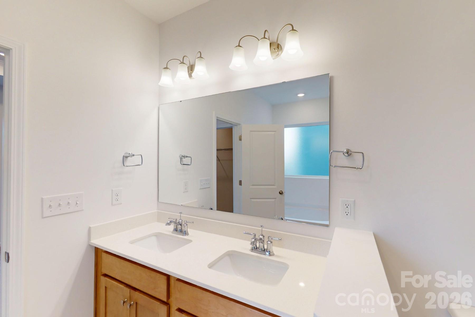 929 Barker Street Monroe, NC 28112 - Photo 24 of 26 a bathroom with a sink vanity and a mirror