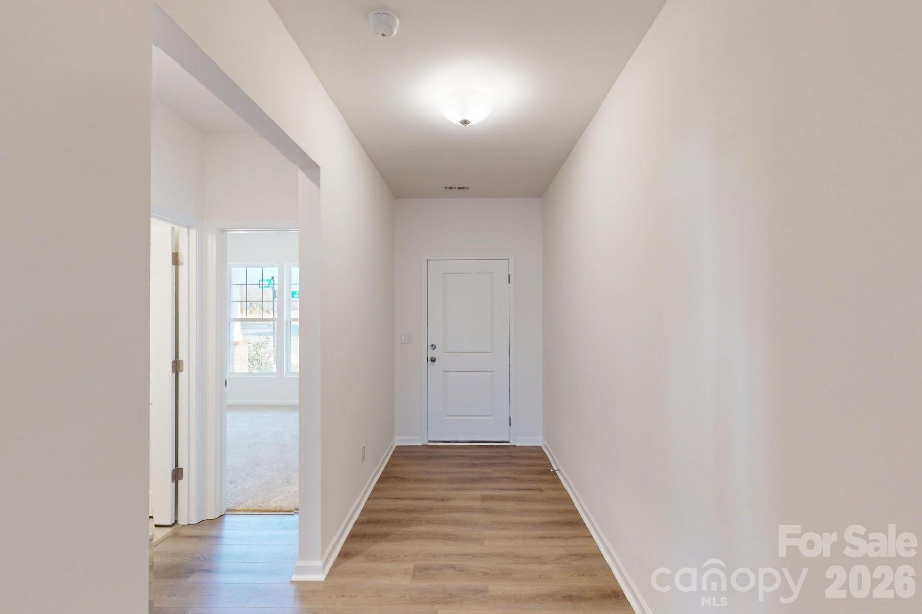 929 Barker Street Monroe, NC 28112 - Photo 4 of 26 a view of a hallway with wooden floor