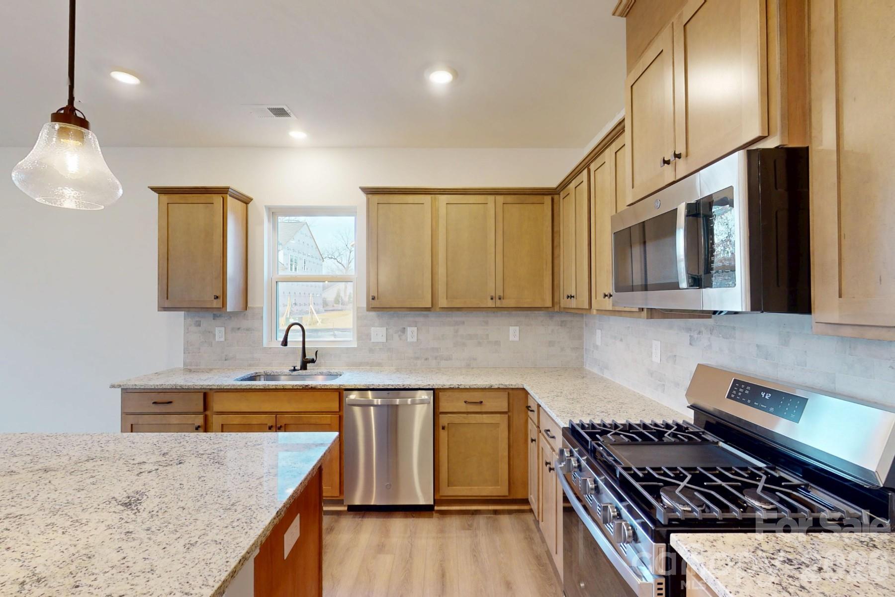 929 Barker Street Monroe, NC 28112 - Photo 5 of 26 a kitchen with a sink stove and microwave