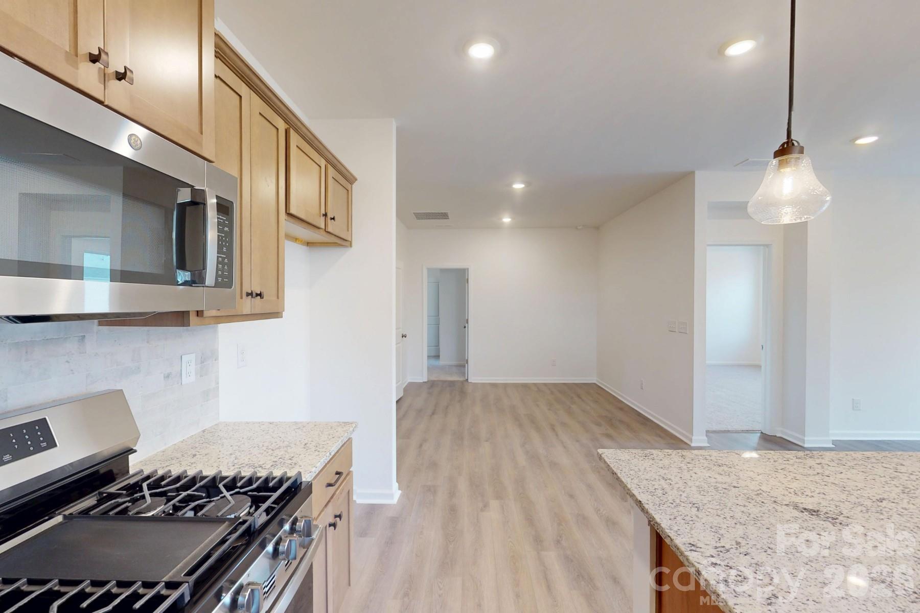 929 Barker Street Monroe, NC 28112 - Photo 10 of 26 a kitchen with a stove and a granite counter tops