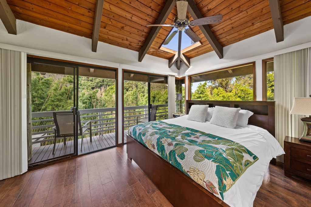 1444 East Kuiaha Road Haiku, HI 96708 - Photo 25 of 30 a bedroom with a bed and wooden floor