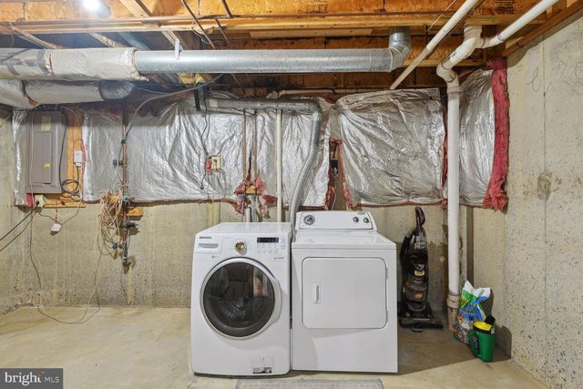 a view of a garden with flowers and wooden fence