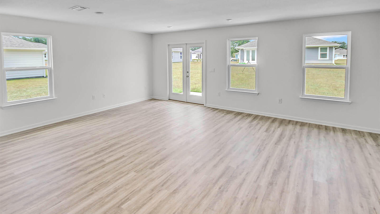 219 Gray Owl Drive Freeport, FL 32439 - Photo 3 of 22 a view of an empty room with window and wooden floor