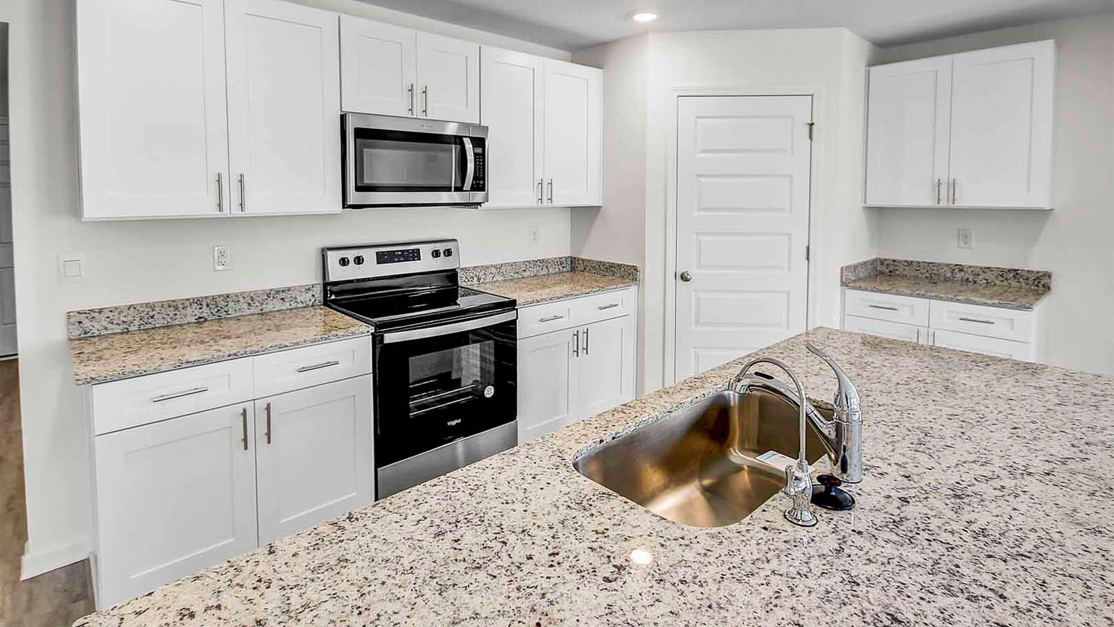 219 Gray Owl Drive Freeport, FL 32439 - Photo 8 of 22 a kitchen with granite countertop a stove sink and cabinets