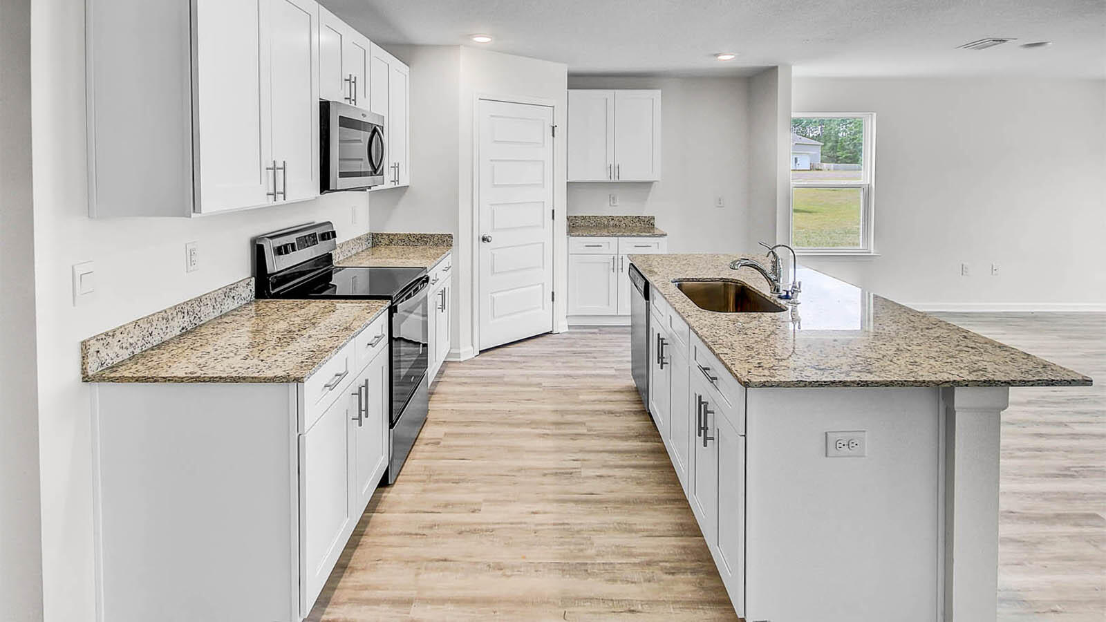 219 Gray Owl Drive Freeport, FL 32439 - Photo 9 of 22 a kitchen with stainless steel appliances granite countertop a sink stove and refrigerator