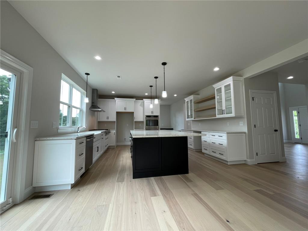 5043 Chapmans Road Orefield, PA 18069 - Photo 13 of 30 Culinary aspirations come alive in this well-appointed kitchen, featuring a spacious island and gleaming hardwood floors.