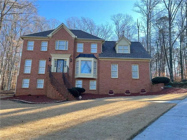 a front view of a house with a yard