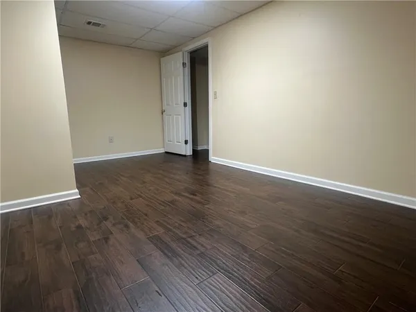a view of an empty room with wooden floor