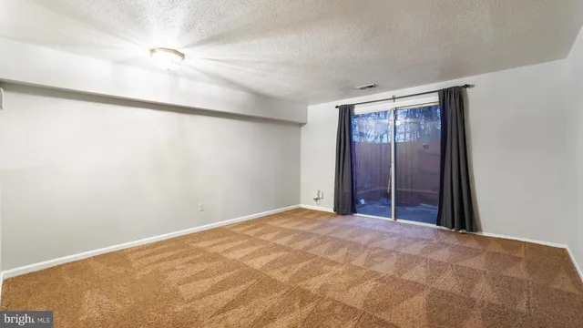 a view of empty room with ceiling fan