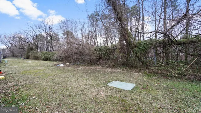 a backyard of a house with a yard and outdoor seating